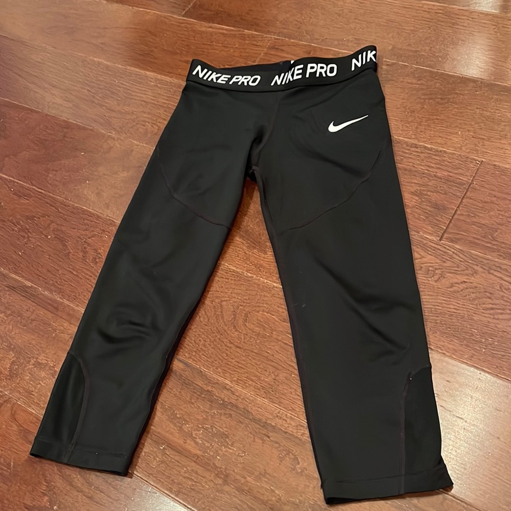 Black knee high Nike Pro pants.